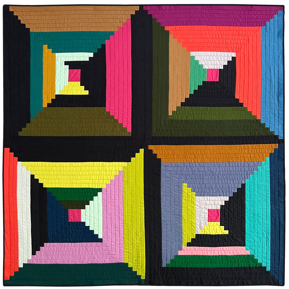 Close up of Big Log Cabin quilt in a rainbow of multiple colors.