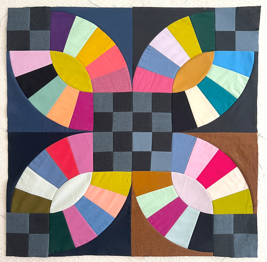 Colorful quilt with geometric pattern on a white background