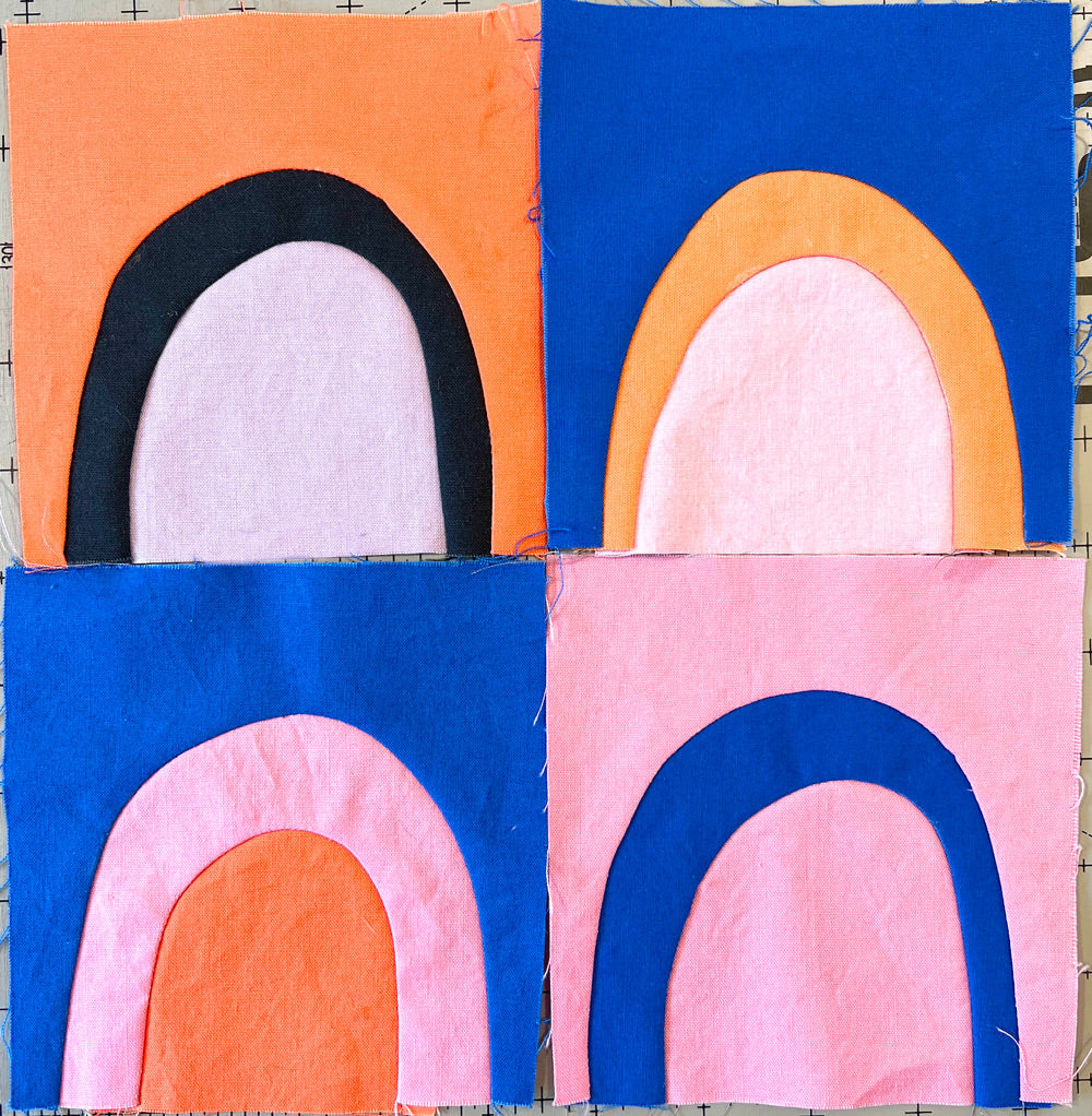 Small quilt blocks of wonky rainbow shapes in bright cheerful colors.