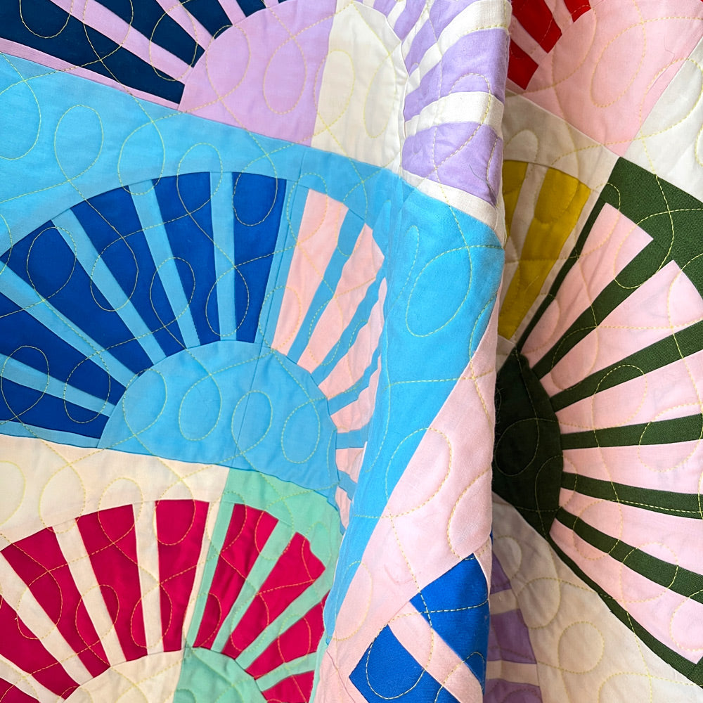 Close up of Sunny quilt blocks showing quilting stitches