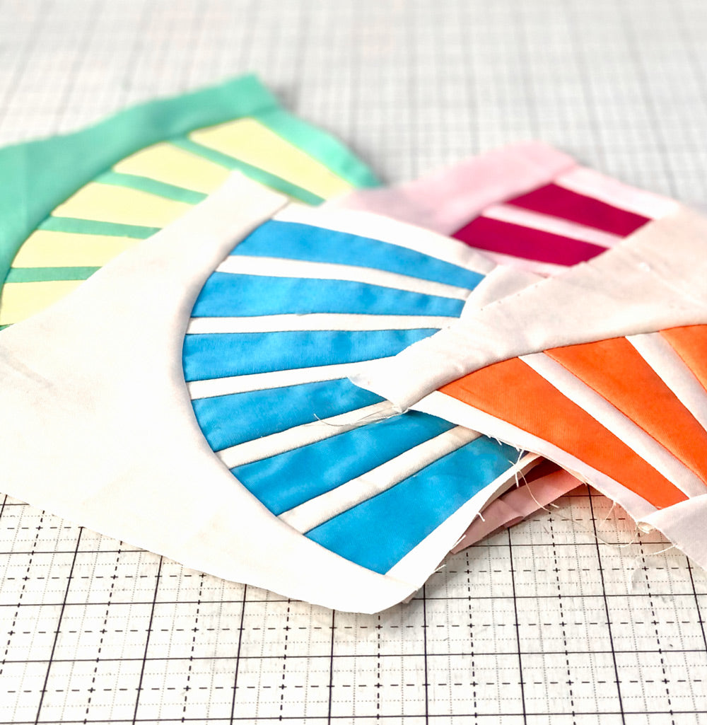 Close up of individual quilt blocks in bright fun colors.