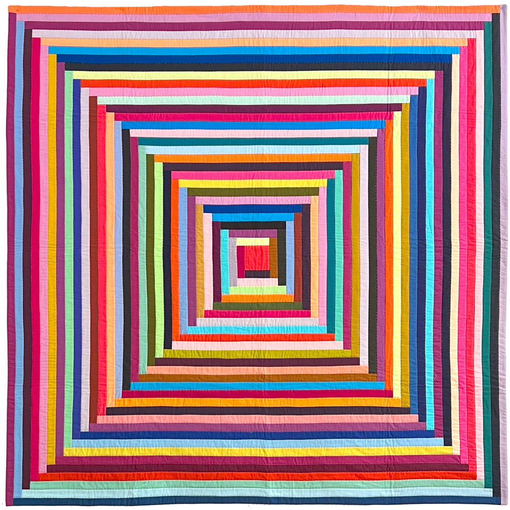 Big Log Cabin quilt in a rainbow of multiple colors.