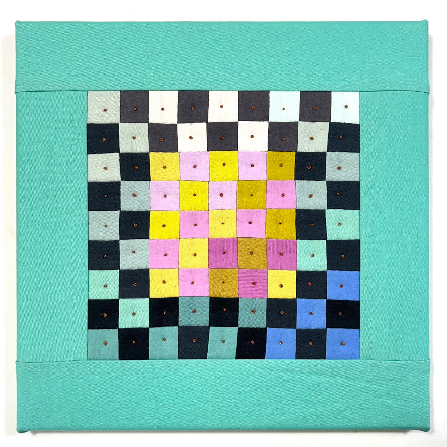 A small quilted wall art composed of multiple bright color squares that is hand pieced, hand quilted and stretched on archival acid free canvas.