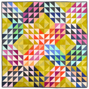 A throw quilt made of half square triangles in an "x" pattern. Made of rainbow colors.