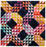 A throw quilt made of half square triangles in an "x" pattern. Made of rainbow colors and a dark navy background.