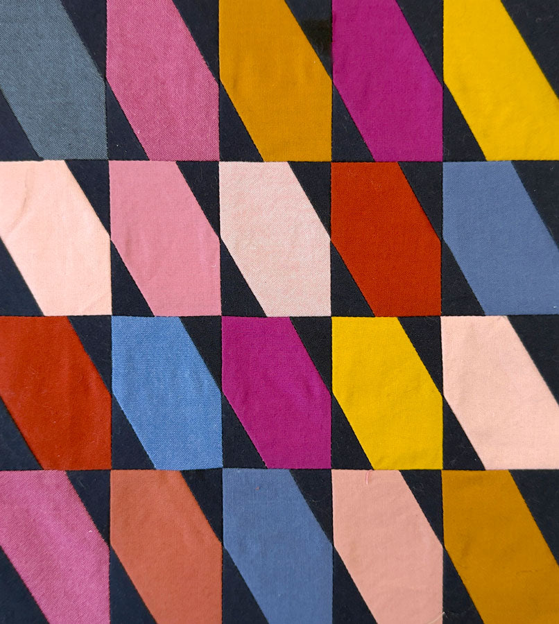Colorful geometric pattern on a textured fabric surface