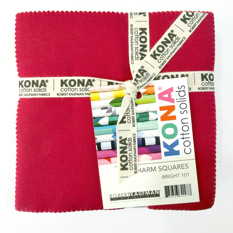 A package of Kina charm squares in bright colors, wrapped with a ribbon.