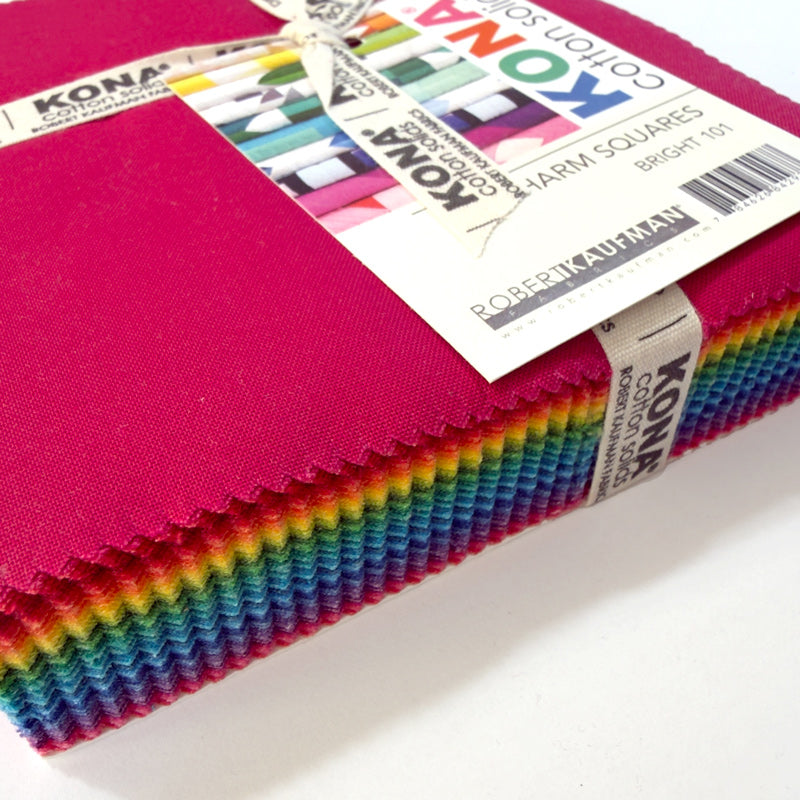 A close up of package of Kina charm squares in bright colors, wrapped with a ribbon.