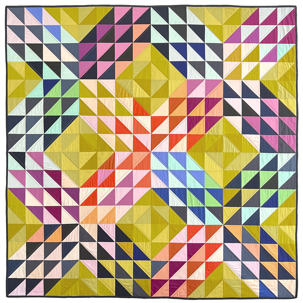colorful quilt made of half square triangle quilt blocks in an X shape