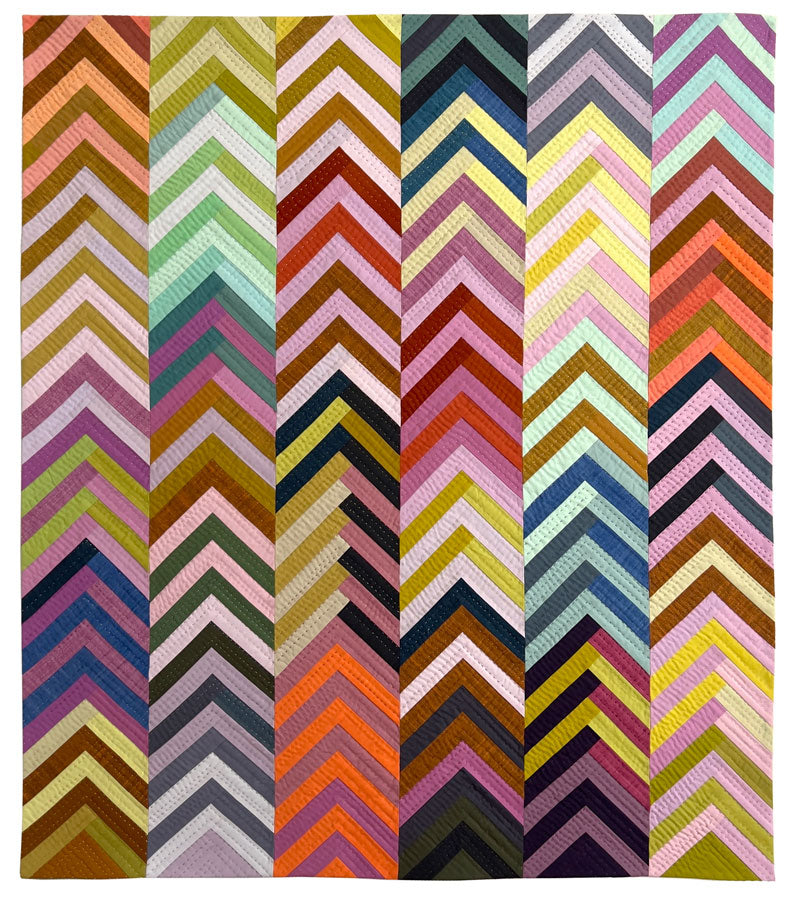 A square textile or rug featuring a bold chevron pattern made of many vertical stripes in assorted colors including pink, orange, yellow, green, blue, purple, brown, and black.