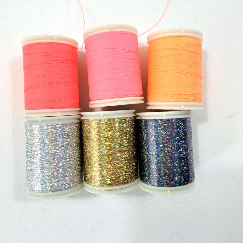 Set of colorful spools of thread on a white background