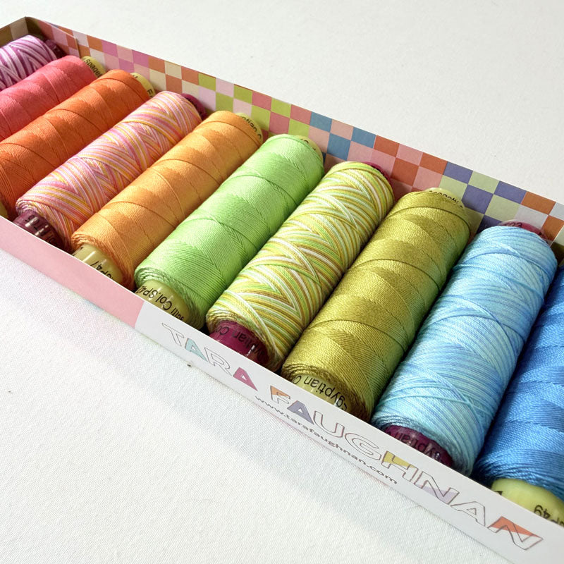Box of colorful yarn rolls with a checkered lid