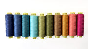 Set of colorful spools of thread on a white background