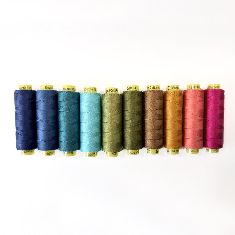 Set of colorful spools of thread on a white background