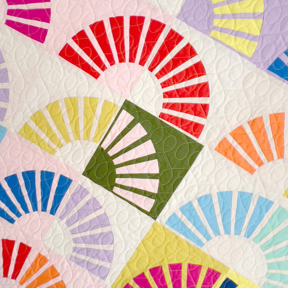 Close up of Sunny quilt blocks showing quilting stitches