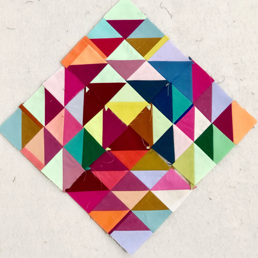 Colorful quilt made of half square triangle blocks.
