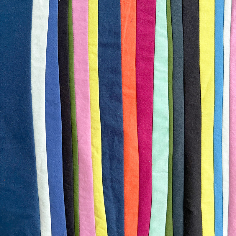 Sewn lines of various widths in multiple bright colors.