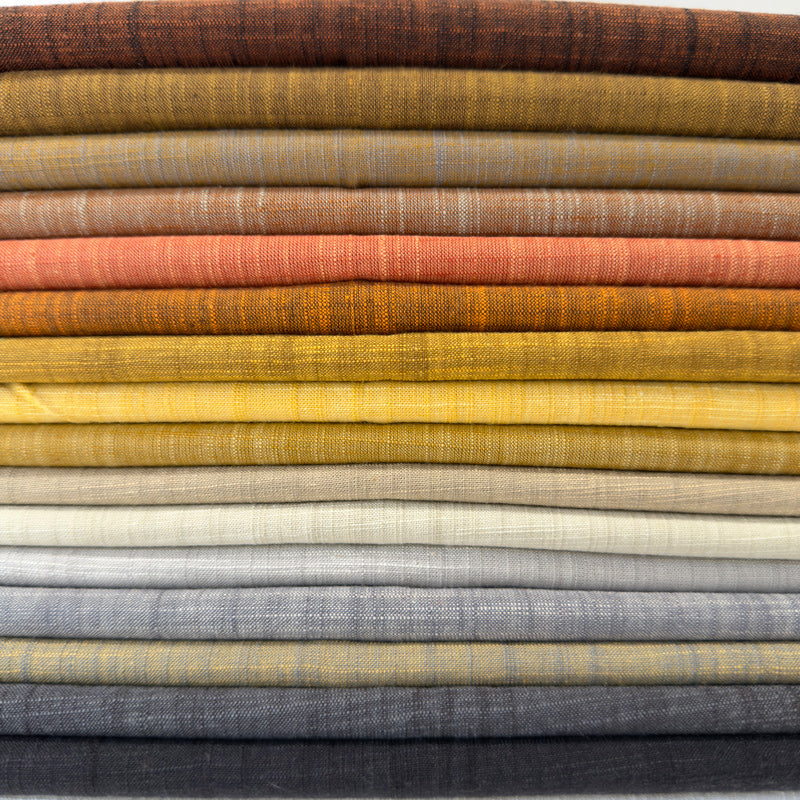 Stack of folded fabric swatches in various colors