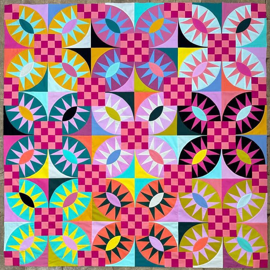 Colorful quilt with geometric pattern on a rock patio surface