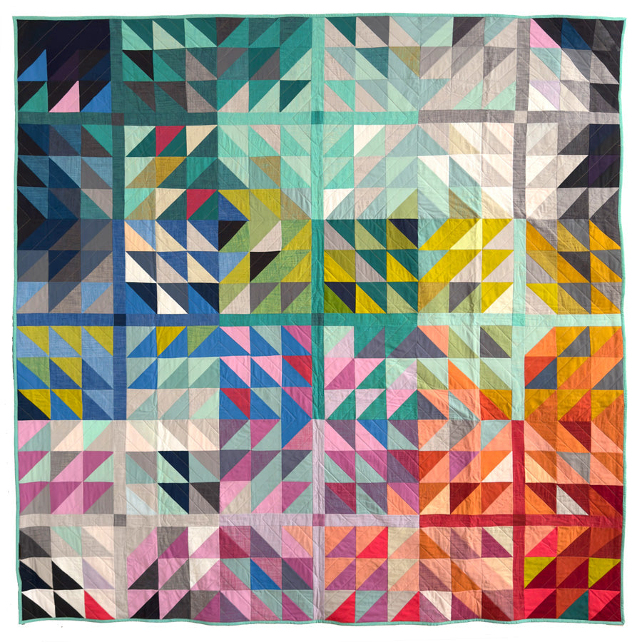 Colorful geometric quilt with triangular patterns on a white background
