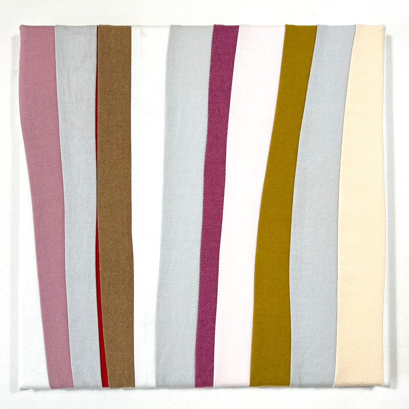 small quilted wall art composed of thick and thin lines in white, pink, black and gold.