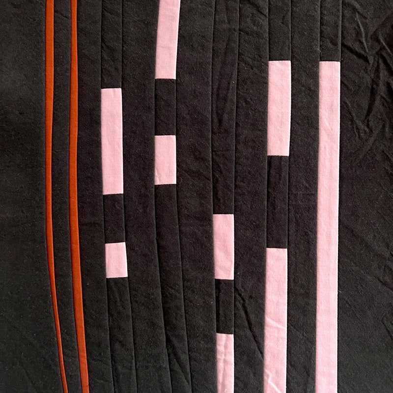 Sewn lines of various widths in pinks, rust and black