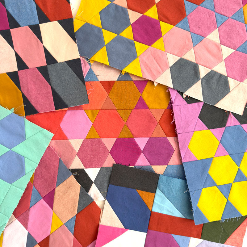 Colorful geometric quilt with variously shaped patches on a white background