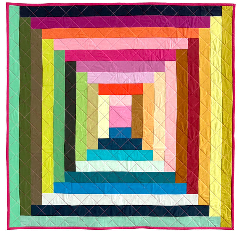 Close up of Big Log Cabin quilt in a rainbow of multiple colors.