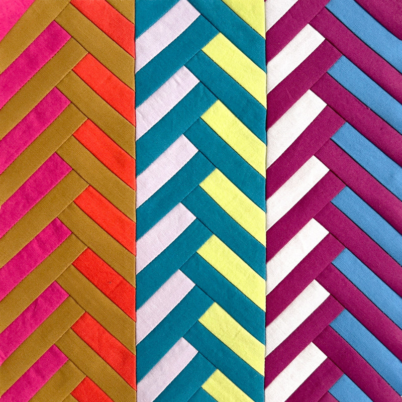 Three panels of colorful chevron-patterned fabric in pink, orange, blue, green, and purple.