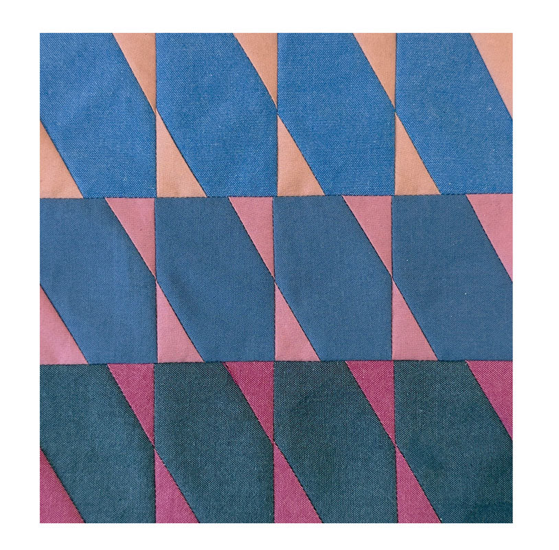 Geometric patterned fabric with blue and pink shapes on a white background