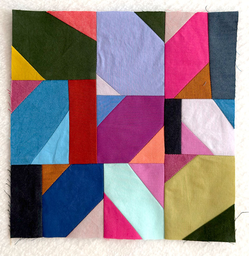 Colorful geometric quilt block on a white background