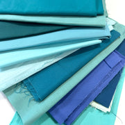 Stack of blue and green fabric swatches
