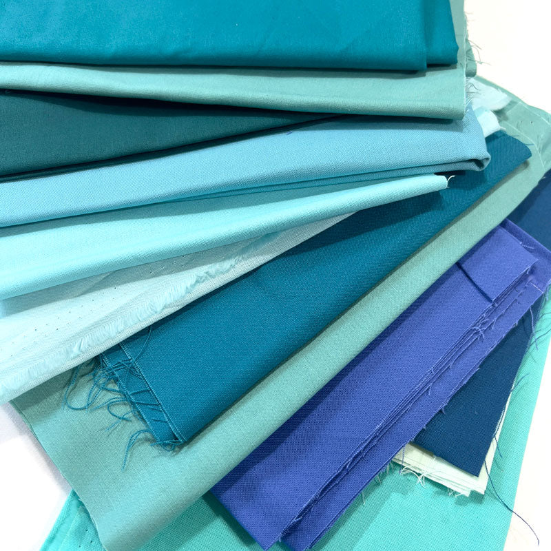 Stack of blue and green fabric swatches