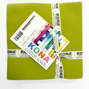A close up of package of Kina charm squares in bright colors, wrapped with a ribbon.