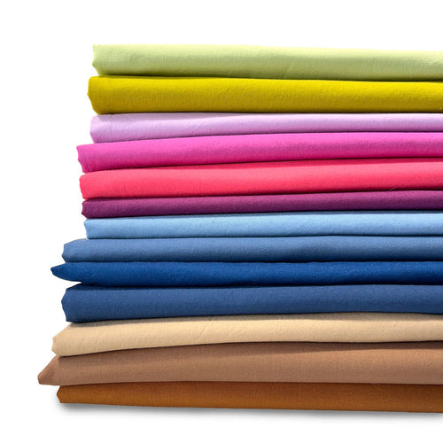 Stack of colorful folded fabrics on a white background