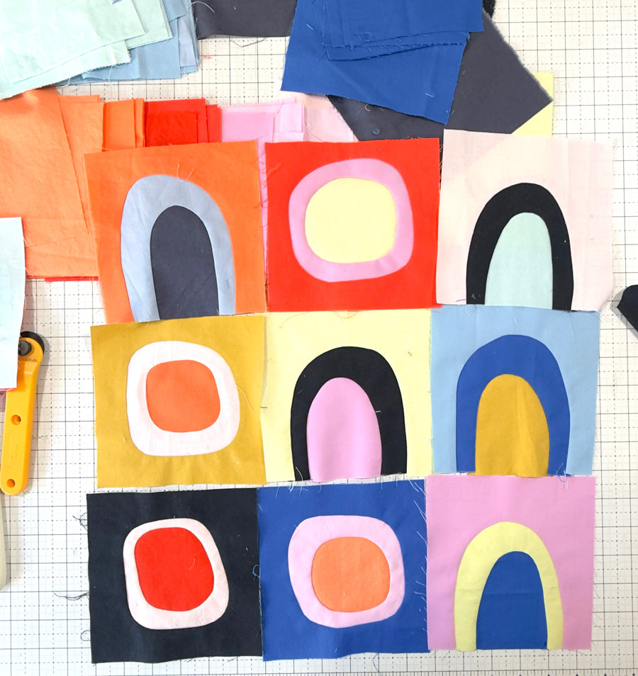 Small quilt blocks of wonky circle and rainbow shapes in bright cheerful colors.