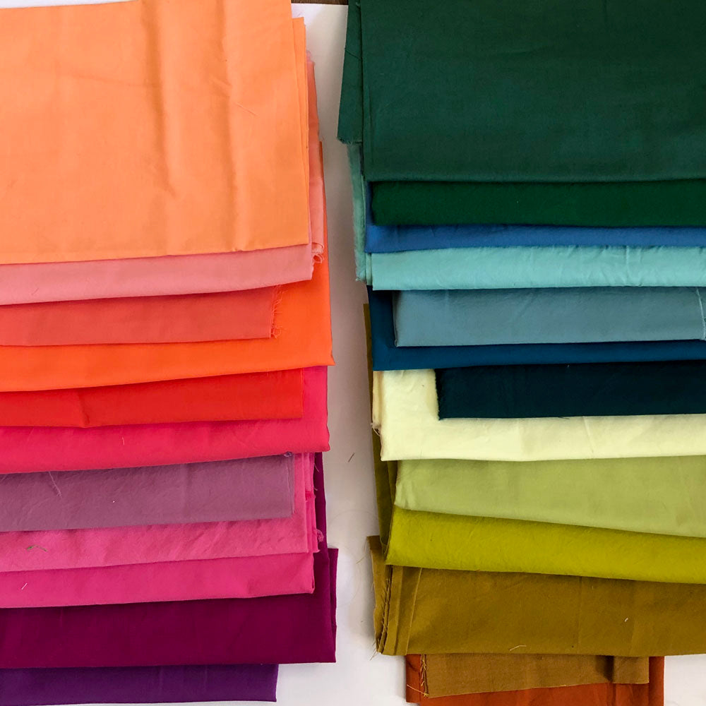 A pile of rainbow colored fabrics