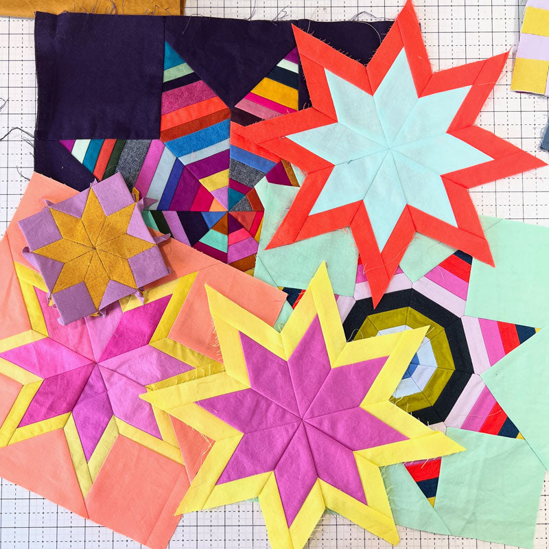 Colorful star-shaped quilt blocks on a grid background