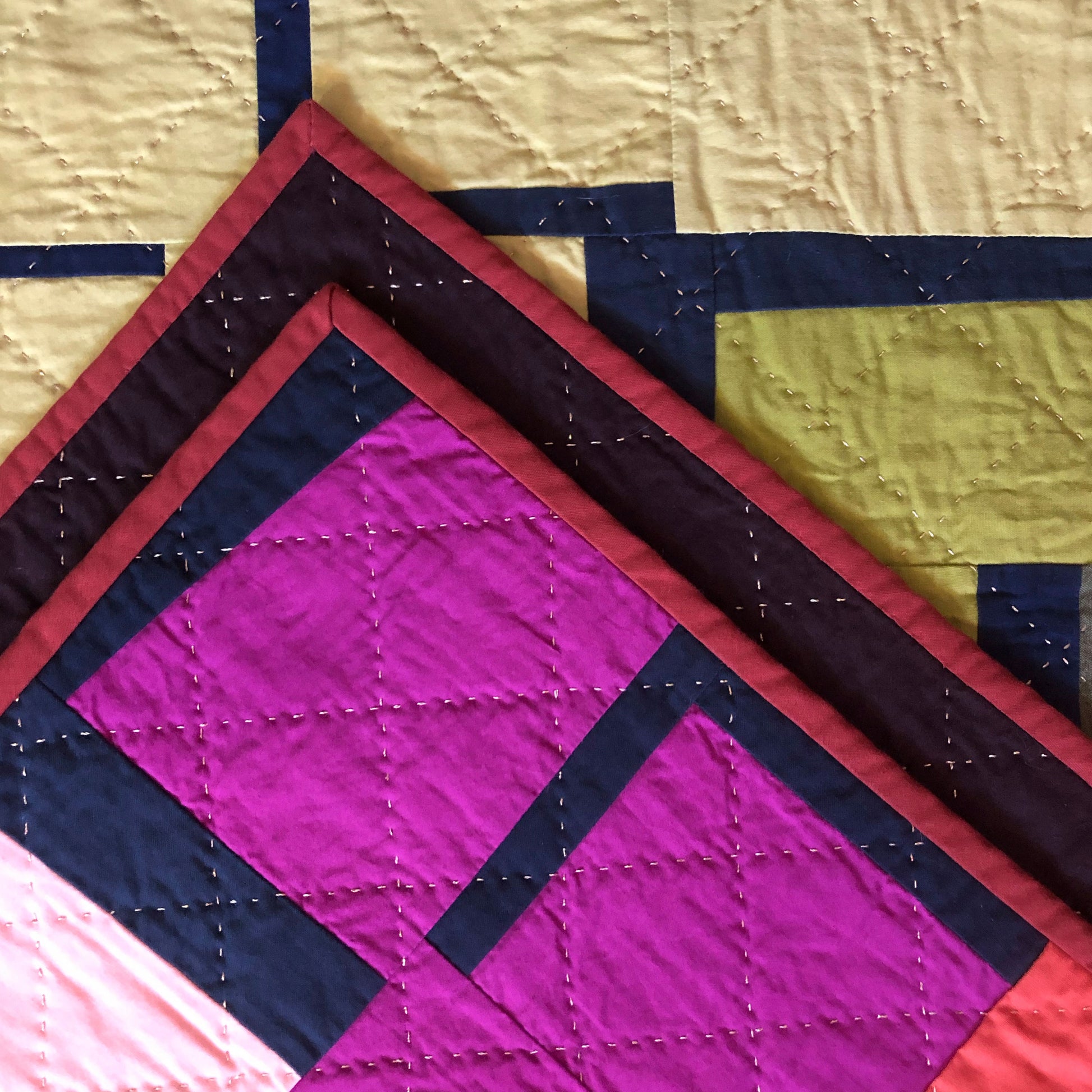 Close up of hand quilting on the give and take quilt top