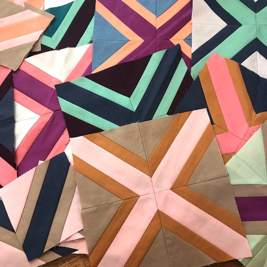 quilt blocks of x shapes in a pile