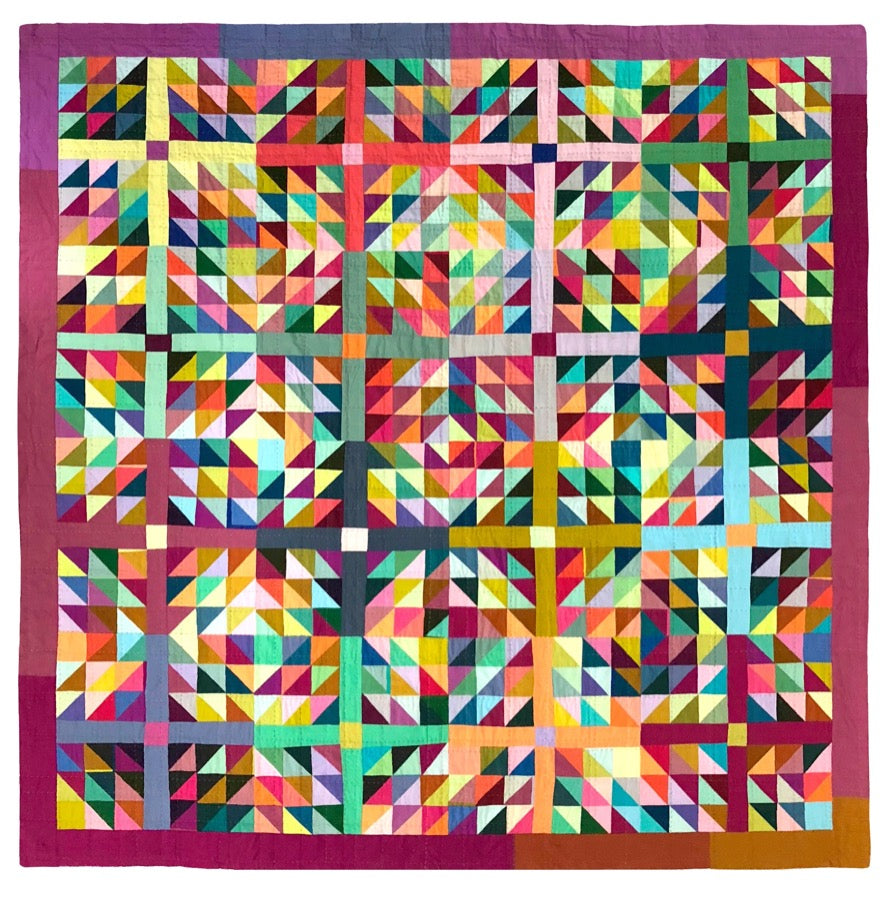 Colorful quilt made of half square triangle blocks with multi colored sashing.