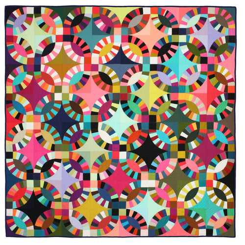 A colorful Double Wedding Ring quilt with intricate geometric patterns with hand quilting detail.