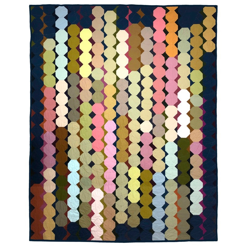 snowball quilt made of irregular hexagons on a dark background