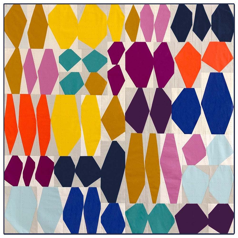 quilt made up of rock like shapes on a pale background