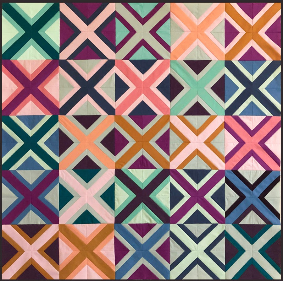 a quilt made of x shaped blocks.