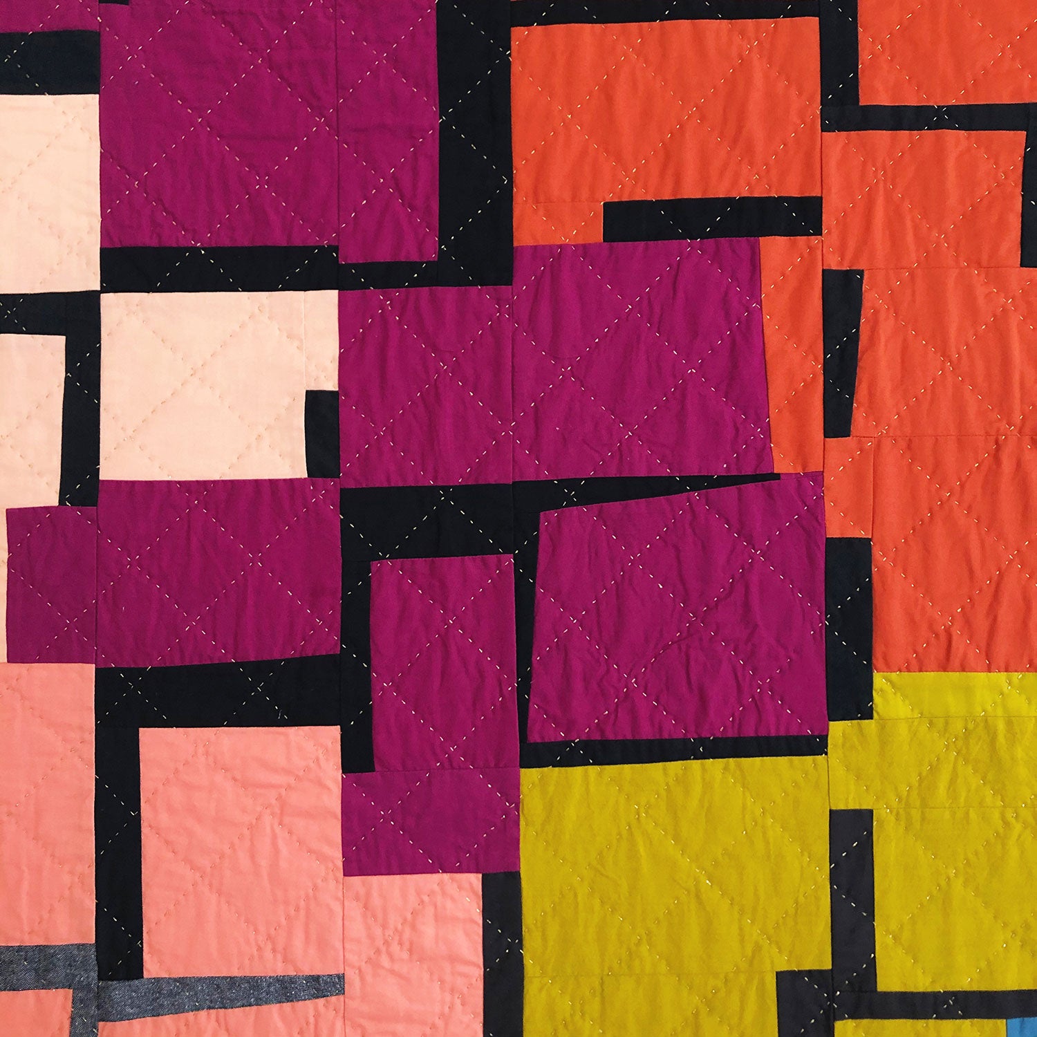 Close up of hand quilting on the give and take quilt top
